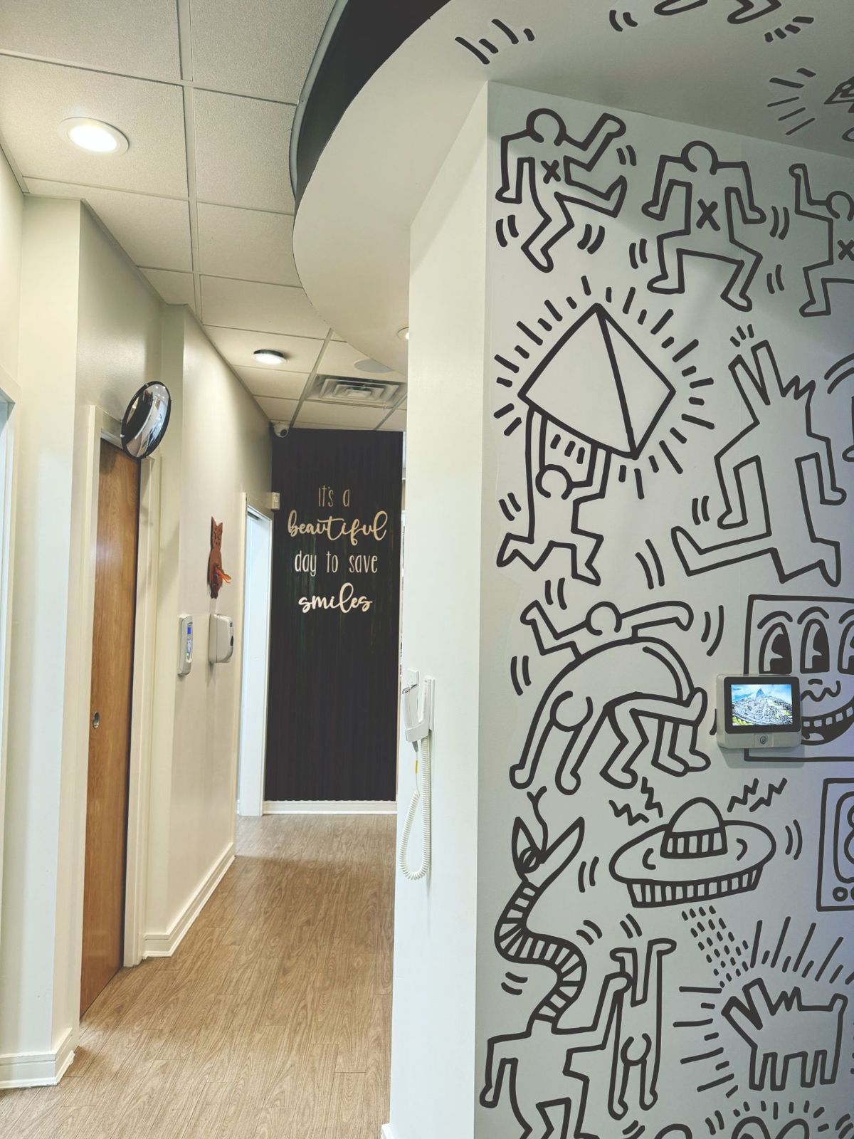 A hallway with a black-and-white doodle mural