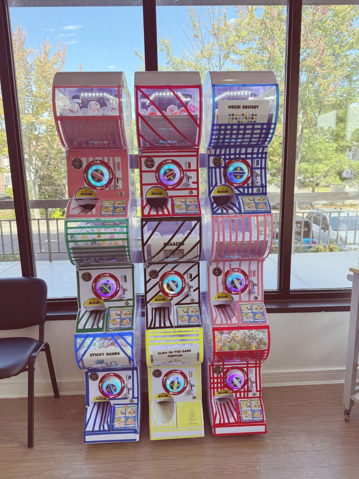 Colorful prize machines by the window, where children spend their token coins